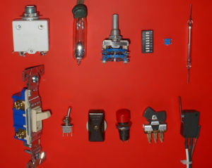 Electrical switches. Top, left to right: circuit breaker, mercury switch, wafer switch, DIP switch, surface mount switch, reed switch. Bottom, left to right: wall switch (U.S. style), miniature toggle switch, in-line switch, push-button switch, rocker switch, microswitch.