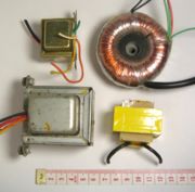 Various transformers. The top right is toroidal. The bottom right is from a 12 VAC wall wart supply.